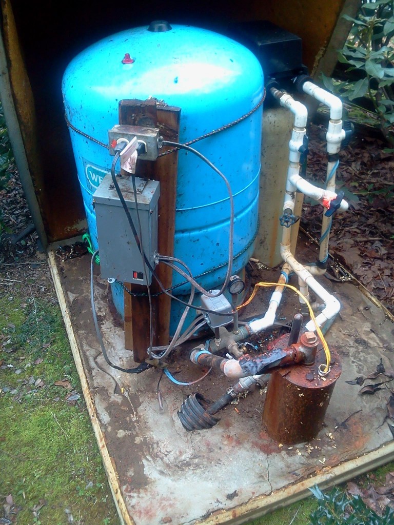 Electrical backer board strapped to pressure tank- No test tap at the well head. No Sediment filter..